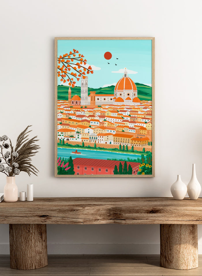 A colorful illustrated cityscape of Florence with the famous dome, towers, clustered buildings, a river, trees, and a red sun in the sky. Shop Florence Autumn Glow by Nidhi Kachhadiya, a colorful Florence wall art print featuring the Duomo, terracotta rooftops, autumn leaves, and warm orange tones.