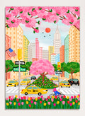 A colorful illustrated city street scene with pink cherry blossoms overhead, yellow NYC taxis, tall buildings, a bicycle with a pink basket, flowers in the foreground, and street signs including Fifti Ave. Shop NYC Cherry Blossoms by Nidhi Kachhadiya, a colorful New York City wall art print with Fifth Avenue, yellow taxis, pink blossoms, and spring city charm.