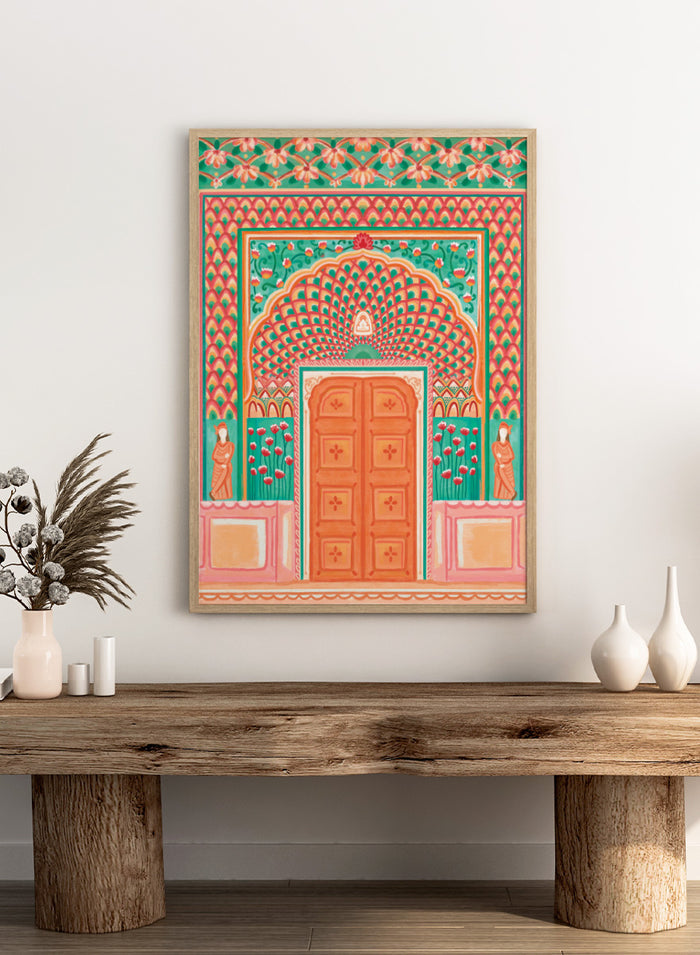 A colorful traditional Indian-style architectural artwork depicting an ornate arched doorway with a peach-orange double door, teal and pink patterned walls, floral motifs, and small statue figures on either side. Shop Vibrant Indian Archway by Nidhi Kachhadiya, a colorful Indian wall art print featuring an ornate archway, floral details, and coral pink tones.