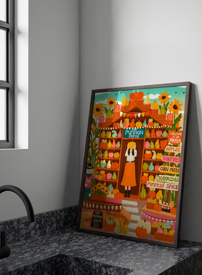 A colorful autumn-themed illustration of a woman standing in the doorway of 'The Pumpkin Patch' market stall, surrounded by shelves of pumpkins and gourds, sunflowers, corn maze signs, and a pumpkin sale chalkboard. Shop Vibrant Pumpkin Patch by Nidhi Kachhadiya, a colorful fall art print featuring pumpkins, gourds, sunflowers, and playful autumn market details.