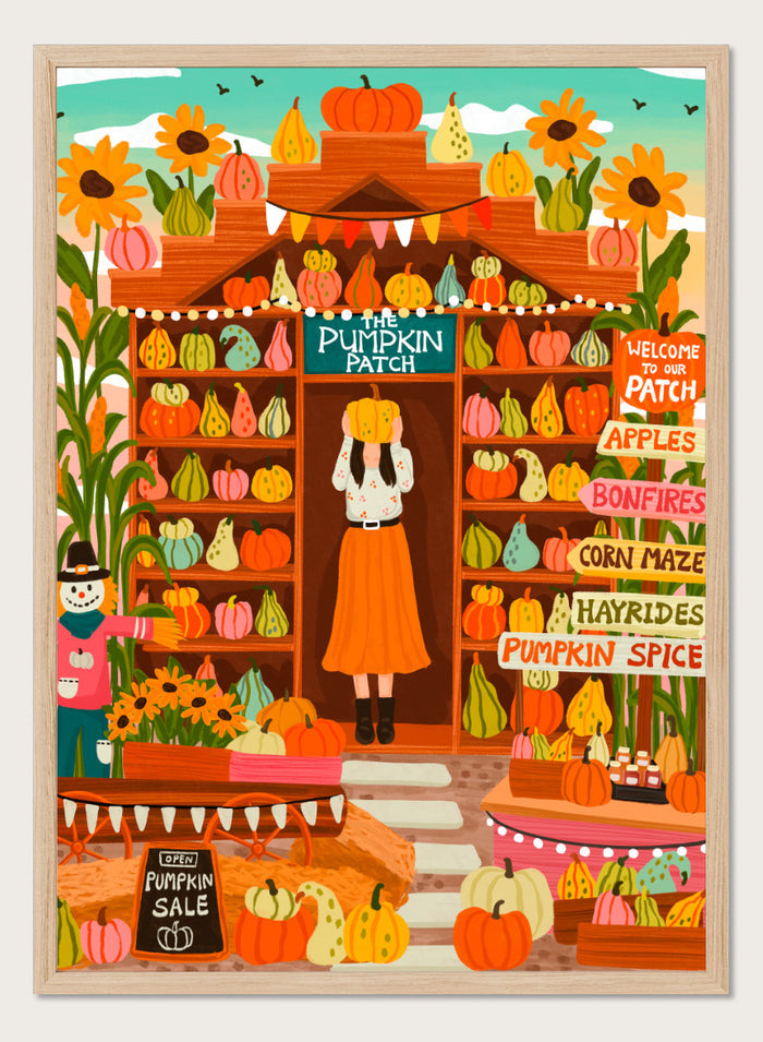 A colorful autumn-themed illustration of a woman standing in the doorway of 'The Pumpkin Patch' market stall, surrounded by shelves of pumpkins and gourds, sunflowers, corn maze signs, and a pumpkin sale chalkboard. Shop Vibrant Pumpkin Patch by Nidhi Kachhadiya, a colorful fall art print featuring pumpkins, gourds, sunflowers, and playful autumn market details.
