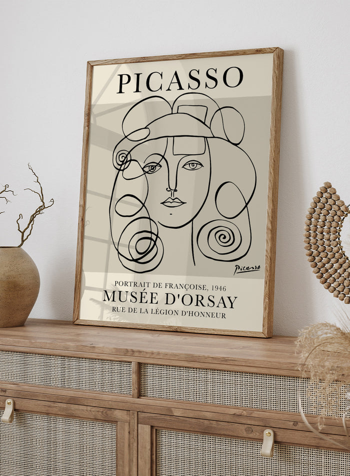 Inspired by Pablo Picasso's original line drawing artwork, this signed lithograph wall art print showcases a portrait of Francoise Gilot 1946 (Portrait de Françoise) in one line art against a white background. This vintage museum exhibition poster by Musee D'orsay is perfect for any boho, retro, or minimalist space.