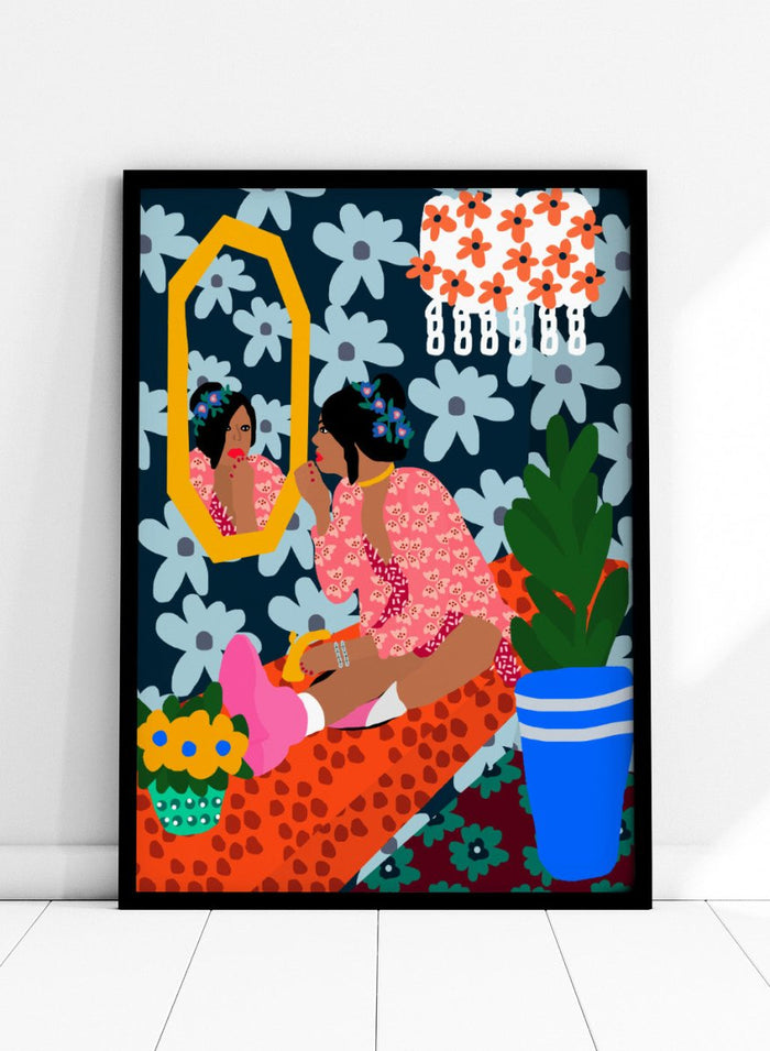 Illustration of a woman applying makeup in front of a mirror with floral patterns and a plant. Before the Mirror by Rafaela Mascaro fine art print poster featuring woman at mirror, bold floral wallpaper, botanical interior, modern contemporary wall art.