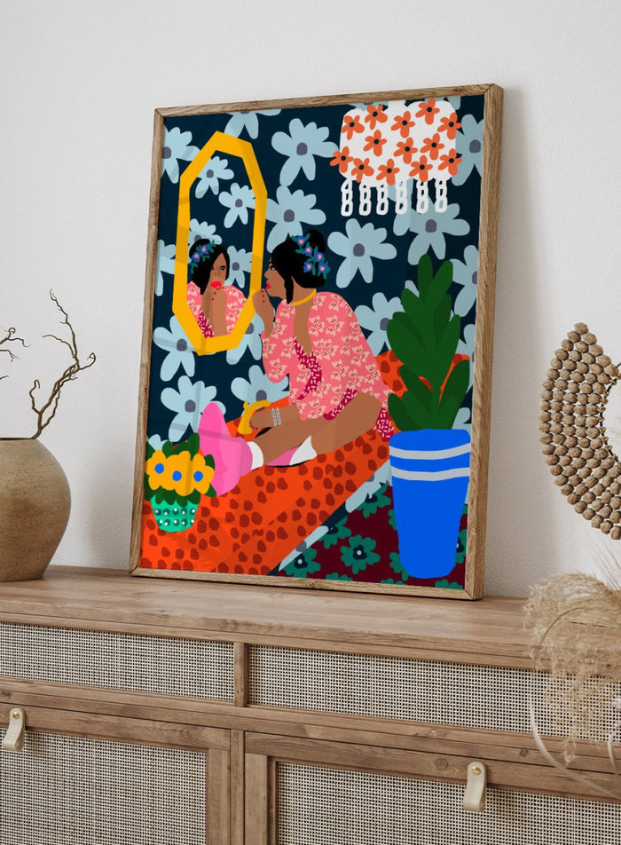Illustration of a woman applying makeup in front of a mirror with floral patterns and a plant. Before the Mirror by Rafaela Mascaro fine art print poster featuring woman at mirror, bold floral wallpaper, botanical interior, modern contemporary wall art.