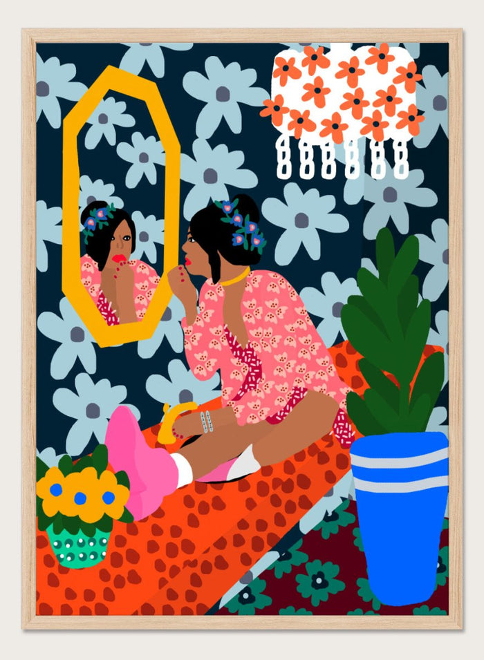 Illustration of a woman applying makeup in front of a mirror with floral patterns and a plant. Before the Mirror by Rafaela Mascaro fine art print poster featuring woman at mirror, bold floral wallpaper, botanical interior, modern contemporary wall art.