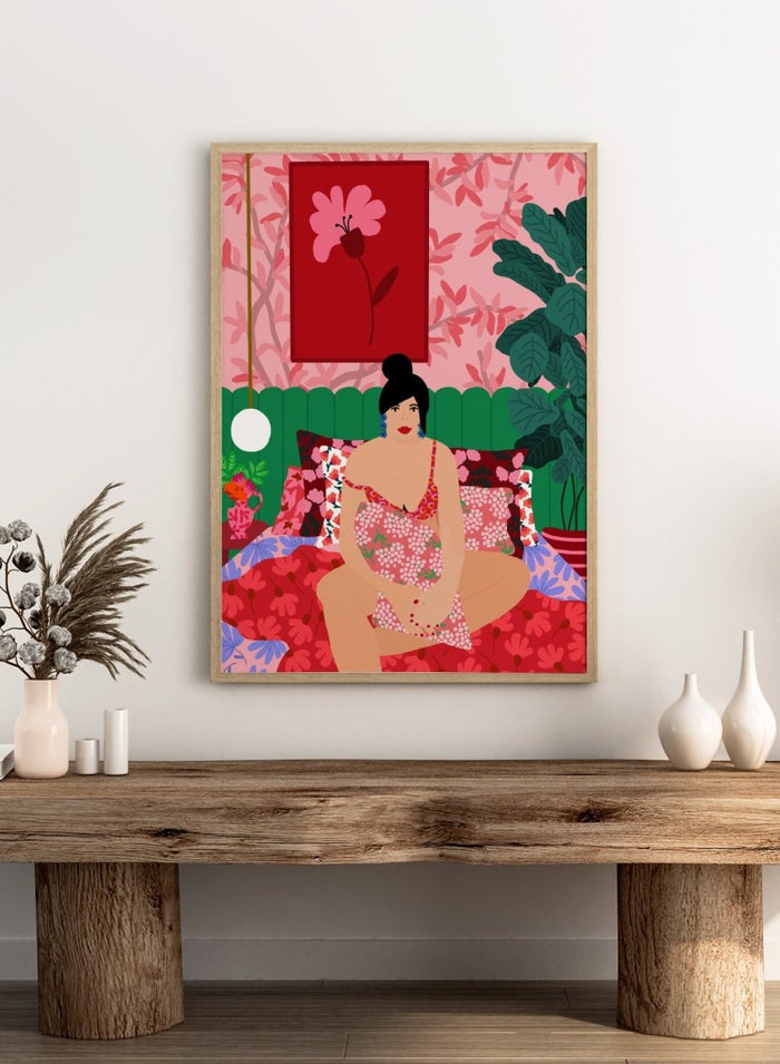 Illustration of a woman in a floral dress sitting on a bed with a colorful room setting. Floral Interior by Rafaela Mascaro is a colorful contemporary art print featuring floral patterns, lush houseplants, vibrant interiors, and joyful home decor inspiration.