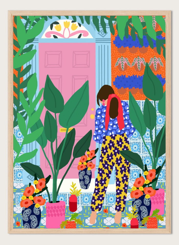 Illustration of a person in colorful pants standing in front of a pink door with plants and flowers. Floral Oasis Retreat by Rafaela Mascaro art print featuring woman in lush garden doorway, colorful plants, patterned tiles, and vibrant contemporary botanical wall art poster.