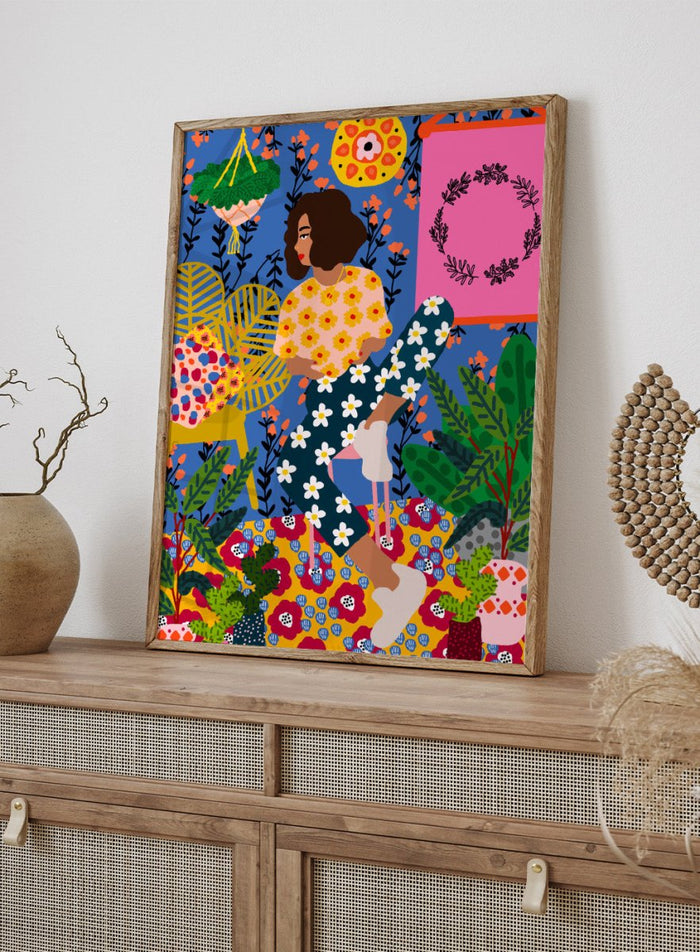 Colorful illustration of a woman sitting among flowers and plants with a vibrant background. Floral Retreat Girl by Rafaela Mascaro fine art print poster with seated woman, bold floral interior, botanical decor, modern contemporary aesthetic wall art.