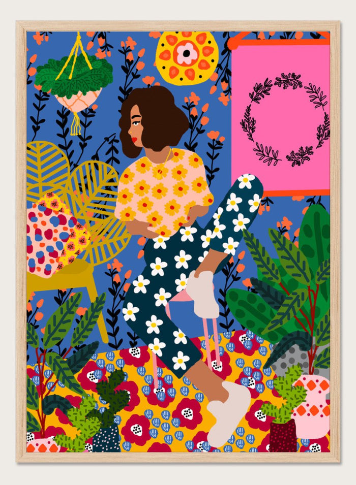 Colorful illustration of a woman sitting among flowers and plants with a vibrant background. Floral Retreat Girl by Rafaela Mascaro fine art print poster with seated woman, bold floral interior, botanical decor, modern contemporary aesthetic wall art.