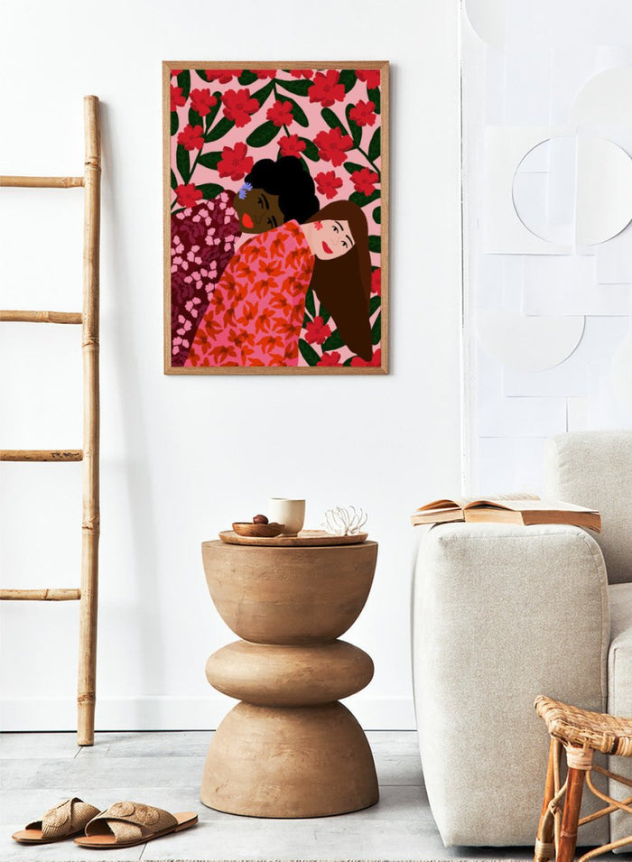 Illustration of two women embracing with a floral pattern in the background. Friendship by Rafaela Mascaro fine art print poster featuring two women embracing, red floral background, modern botanical wall art.