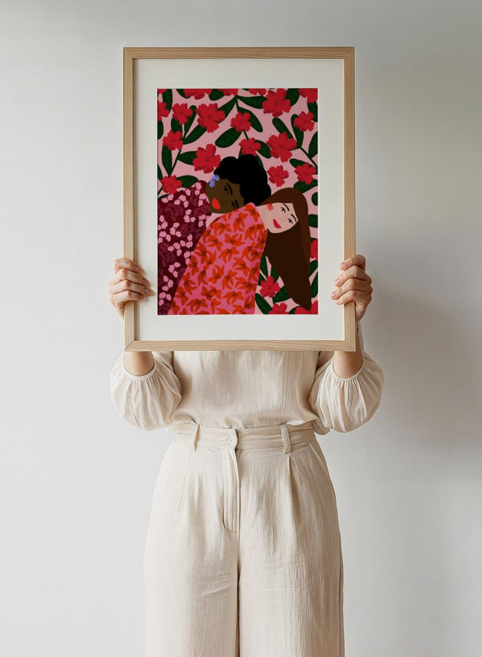 Illustration of two women embracing with a floral pattern in the background. Friendship by Rafaela Mascaro fine art print poster featuring two women embracing, red floral background, modern botanical wall art.