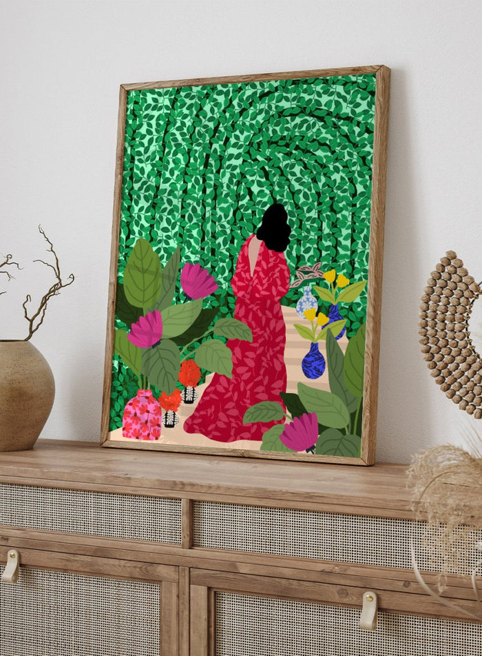 Girl at Her Garden by Rafaela Mascaro fine art print featuring lush green botanical background, red dress figure, and modern contemporary wall art poster.