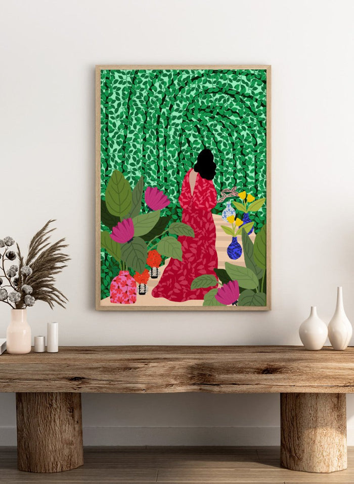 Girl at Her Garden by Rafaela Mascaro fine art print featuring lush green botanical background, red dress figure, and modern contemporary wall art poster.