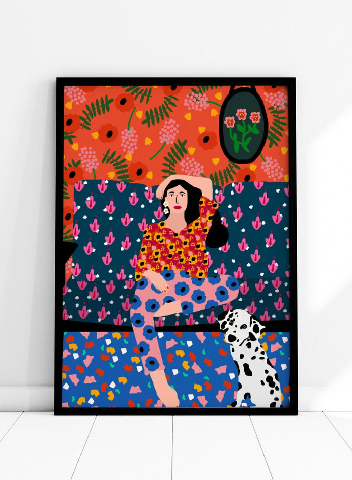 Colorful abstract art piece with a woman and dog on a patterned background. Girl in the Sofa by Rafaela Mascaro fine art print poster featuring lounging woman, Dalmatian dog, bold patterned couch, floral wallpaper, modern contemporary wall art.