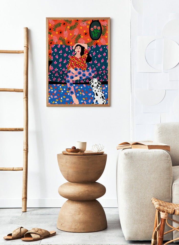 Colorful abstract art piece with a woman and dog on a patterned background. Girl in the Sofa by Rafaela Mascaro fine art print poster featuring lounging woman, Dalmatian dog, bold patterned couch, floral wallpaper, modern contemporary wall art.