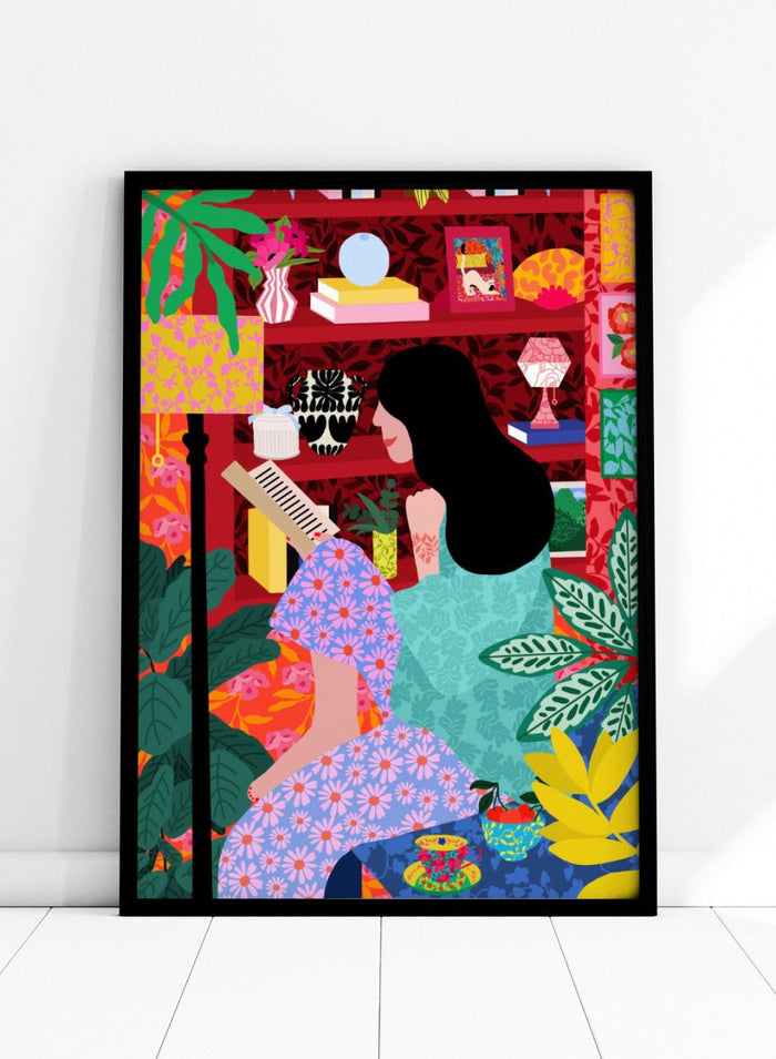 Illustration of a women sitting together with a colorful, patterned background. Girl Reading Her Favorite Book by Rafaela Mascaro fine art print poster featuring woman reading, red bookshelf, bold patterns, plants, modern contemporary wall art.