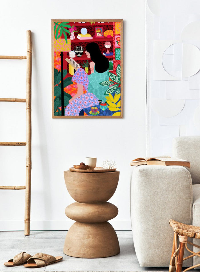 Illustration of a women sitting together with a colorful, patterned background. Girl Reading Her Favorite Book by Rafaela Mascaro fine art print poster featuring woman reading, red bookshelf, bold patterns, plants, modern contemporary wall art.