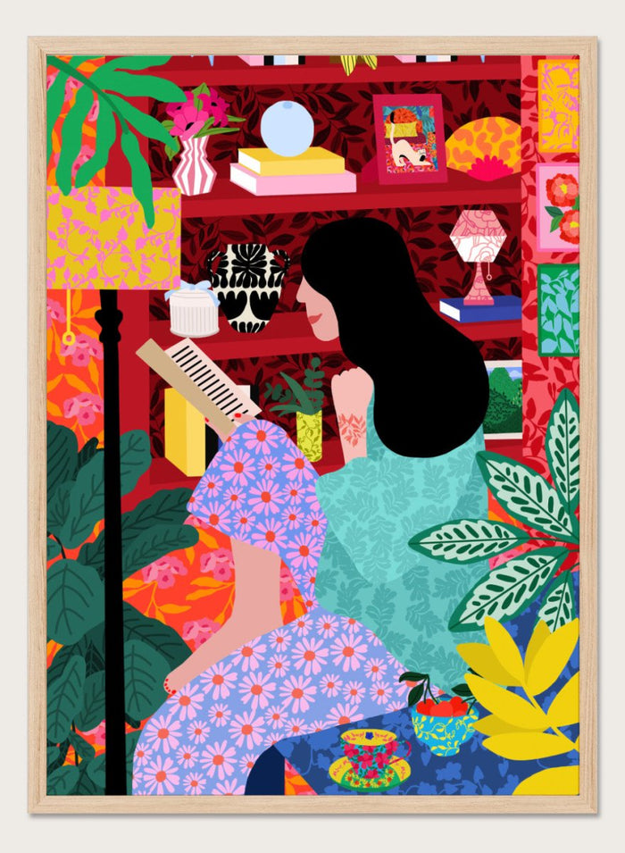 Illustration of a women sitting together with a colorful, patterned background. Girl Reading Her Favorite Book by Rafaela Mascaro fine art print poster featuring woman reading, red bookshelf, bold patterns, plants, modern contemporary wall art.