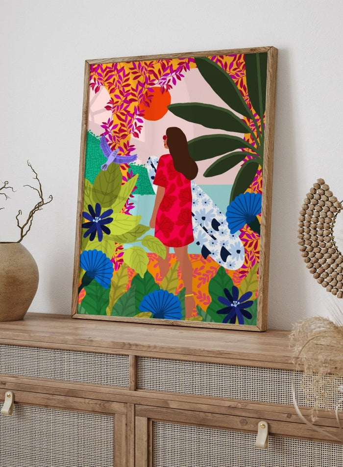 Woman in a red dress with a white surfboard amidst tropical foliage and flowers. Going Surfing by Rafaela Mascaro is a colorful tropical art print featuring a surfer, lush botanicals, vibrant florals, and sunny coastal inspiration.
