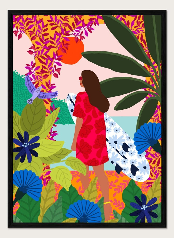 Woman in a red dress with a white surfboard amidst tropical foliage and flowers. Going Surfing by Rafaela Mascaro is a colorful tropical art print featuring a surfer, lush botanicals, vibrant florals, and sunny coastal inspiration.
