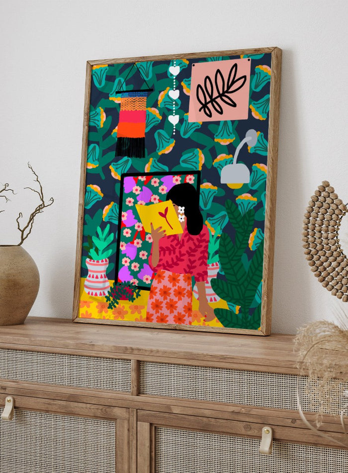 Colorful illustration of a woman reading a book with a vibrant patterned background. In Her Own Pages by Rafaela Mascaro fine art print featuring woman reading book, bold floral wallpaper, botanical interior, modern wall art poster.