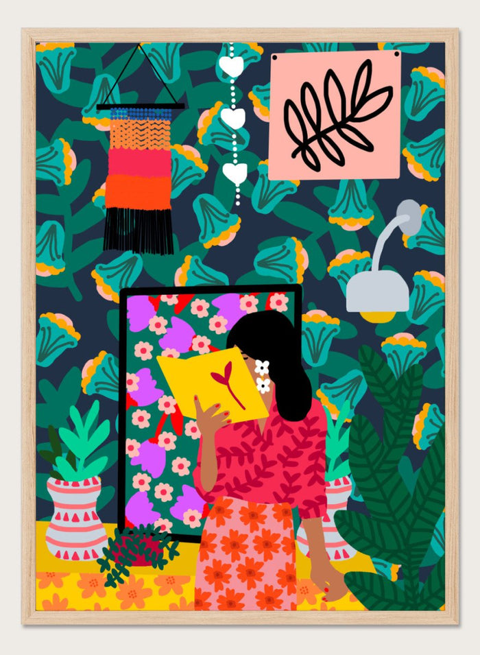 Colorful illustration of a woman reading a book with a vibrant patterned background. In Her Own Pages by Rafaela Mascaro fine art print featuring woman reading book, bold floral wallpaper, botanical interior, modern wall art poster.