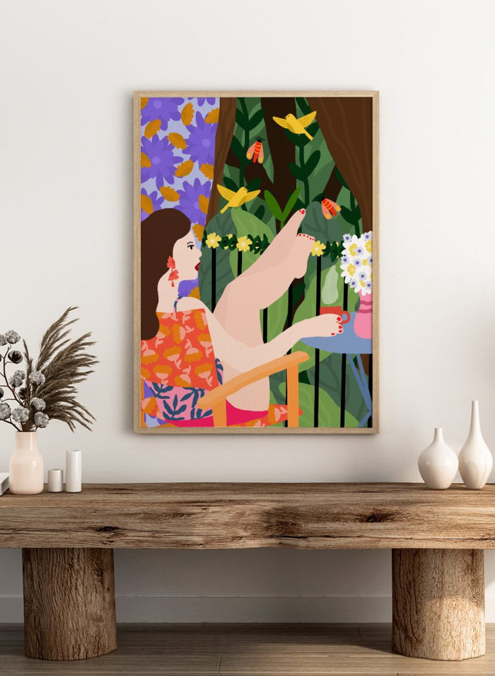Illustration of a woman sitting by a pool with flowers and birds in a colorful garden setting. Morning on the Balcony by Rafaela Mascaro fine art print poster featuring woman with coffee, birds, lush greenery, botanical scene, modern contemporary wall art.