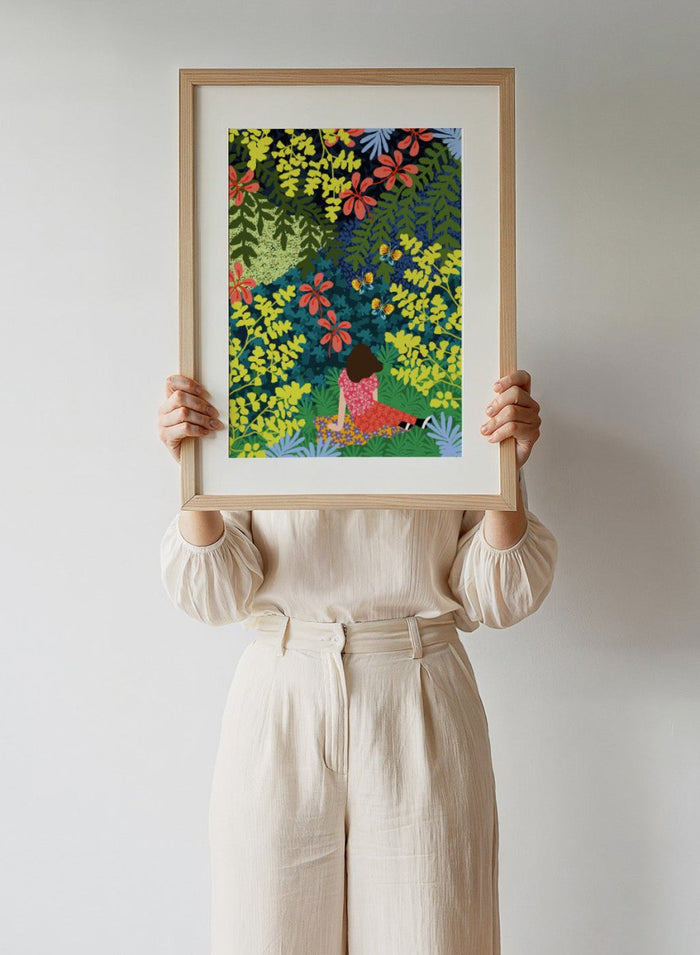 Illustration of a person sitting among colorful flowers and foliage. Picnic in the Forest by Rafaela Mascaro fine art print featuring lush botanical forest, oversized leaves, butterflies, modern colorful wall art poster.