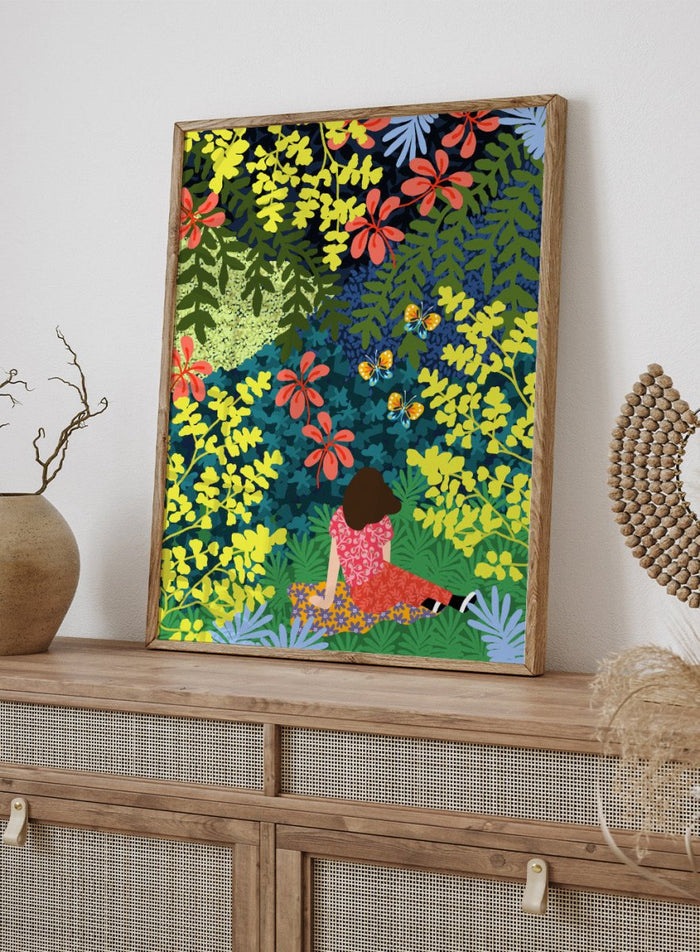 Illustration of a person sitting among colorful flowers and foliage. Picnic in the Forest by Rafaela Mascaro fine art print featuring lush botanical forest, oversized leaves, butterflies, modern colorful wall art poster.