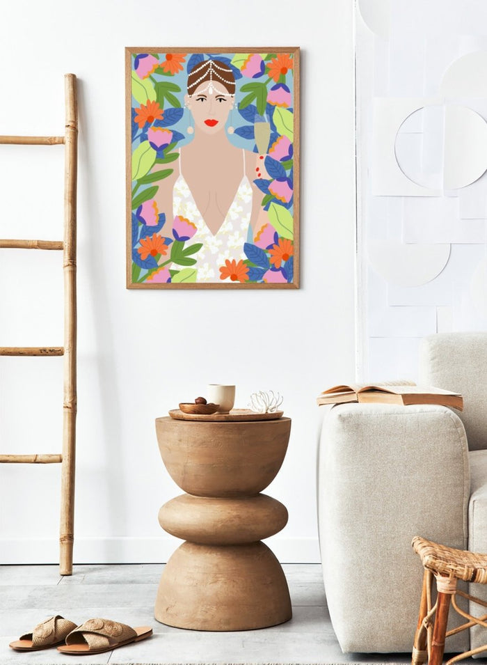 Illustration of a woman with flowers and leaves around her. Summer Queen in Flowers by Rafaela Mascaro is a vibrant floral art print celebrating confidence, femininity, color, and lush botanical beauty.