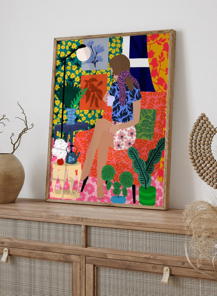 Colorful illustration of a woman holding a plant in a vibrant, patterned room. Tea Time Girl by Rafaela Mascaro fine art print poster featuring woman drinking tea in colorful floral interior, modern contemporary botanical wall art.