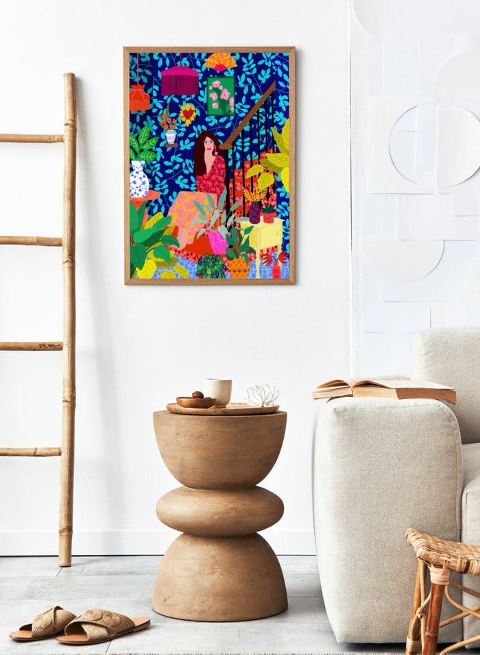 Colorful illustration of a woman sitting among plants and decorative items on a blue background. The Botanical Staircase by Rafaela Mascaro fine art print featuring blue botanical wallpaper, patterned staircase interior, modern contemporary wall art poster.