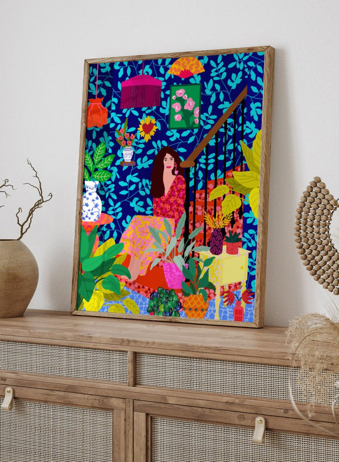 Colorful illustration of a woman sitting among plants and decorative items on a blue background. The Botanical Staircase by Rafaela Mascaro fine art print featuring blue botanical wallpaper, patterned staircase interior, modern contemporary wall art poster.