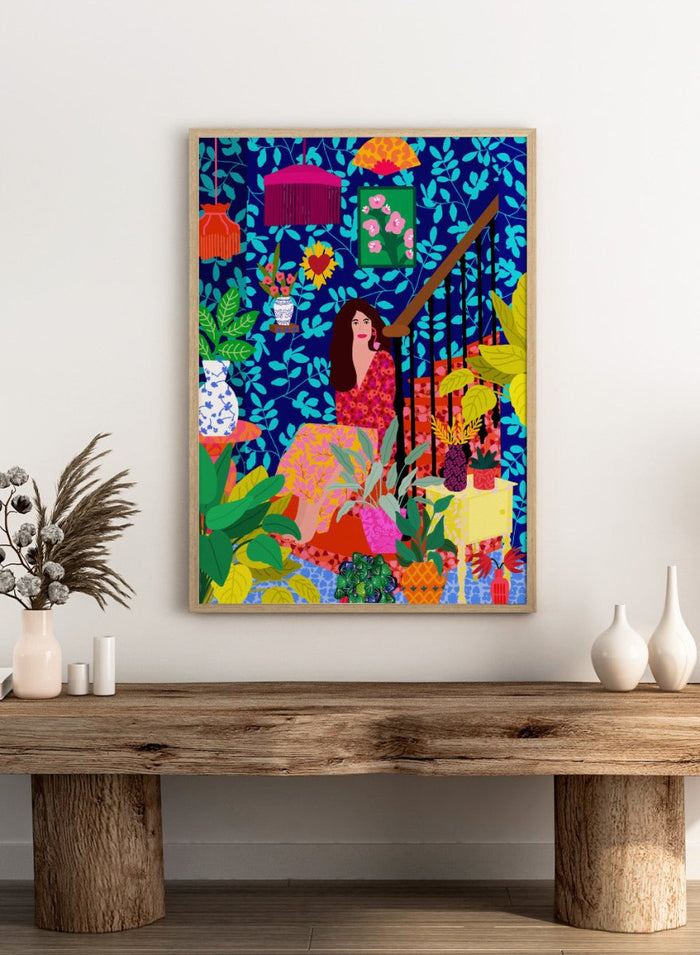 Colorful illustration of a woman sitting among plants and decorative items on a blue background. The Botanical Staircase by Rafaela Mascaro fine art print featuring blue botanical wallpaper, patterned staircase interior, modern contemporary wall art poster.