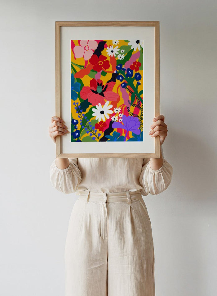 Colorful floral pattern with various flowers on a yellow background. Wildflower Tangle by Rafaela Mascaro botanical art print featuring bold colorful flowers, layered wildflower pattern, and vibrant contemporary floral wall art poster.