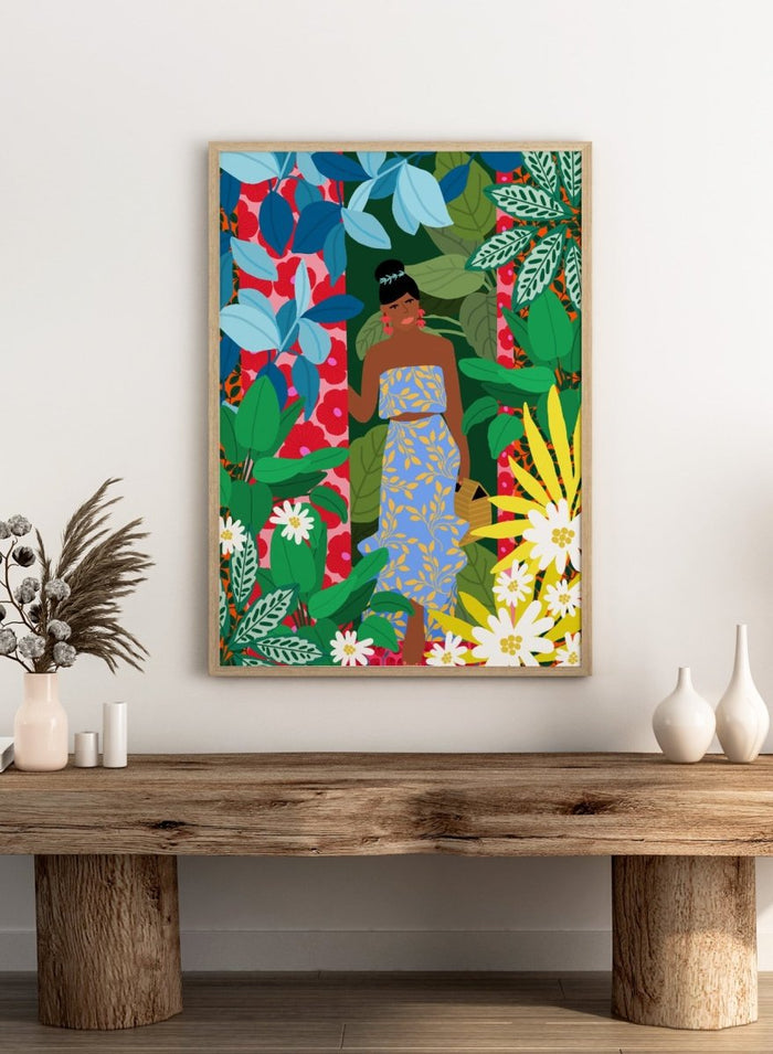 Woman in a blue dress surrounded by colorful foliage and flowers. Woman In A Dress With Flowers by Rafaela Mascaro is a vibrant botanical art print featuring lush foliage, colorful florals, decorative patterns, and tropical charm.