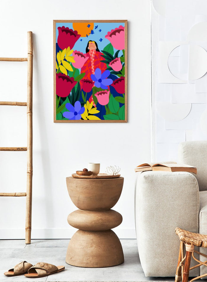 Colorful illustration of a woman surrounded by flowers and birds on a blue background. Woman in Flower Garden by Rafaela Mascaro fine art print poster featuring oversized tulips, bold florals, birds, modern contemporary botanical wall art.