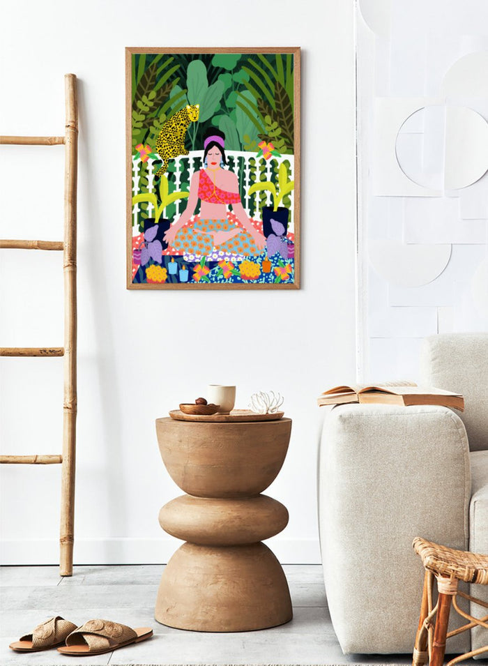 Illustration of a woman in a colorful dress sitting in a garden with plants and flowers. Woman in Lotus Position by Rafaela Mascaro art print featuring meditation figure, tropical plants, leopard balcony scene, and vibrant contemporary botanical wall art poster.