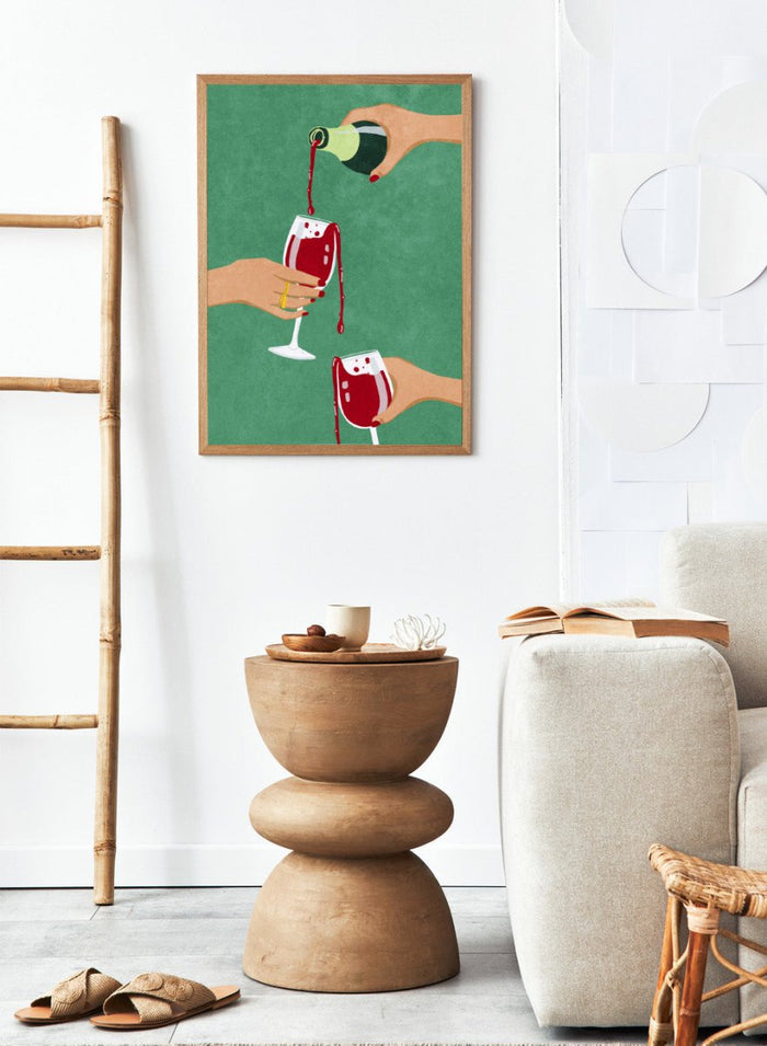 Illustration of hands pouring red wine into glasses on a green background. Cheers Girls by Raissa Oltmanns is a modern wine art print featuring bold red glasses and contemporary girl dinner party wall poster style.