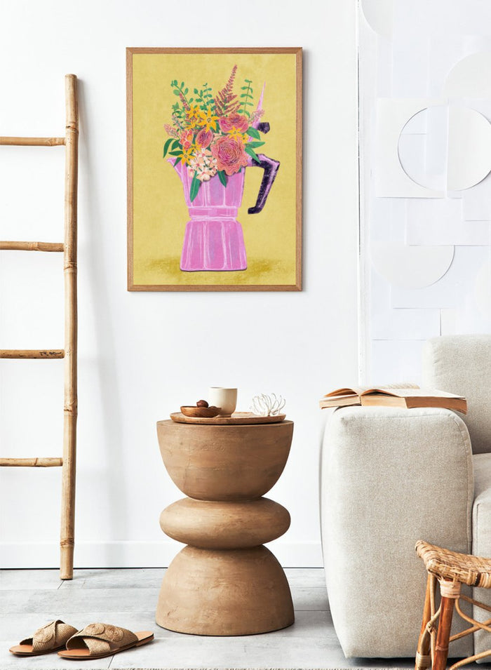Colorful floral arrangement in a pink vase on a yellow background. Espresso Maker with Flowers by Raissa Oltmanns is a modern floral fine art print featuring a pink moka pot vase still life and bold kitchen wall decor poster.