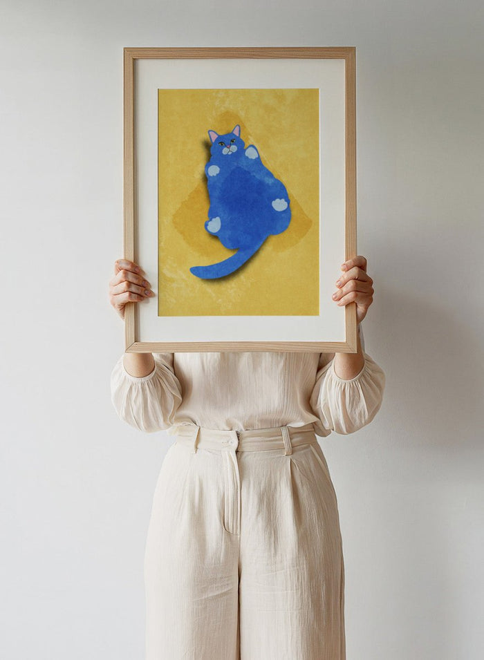 Blue cat illustration on a yellow textured background. Fat Cat by Raissa Oltmanns is a modern cat art print featuring a bold blue feline on yellow background in contemporary wall poster style.