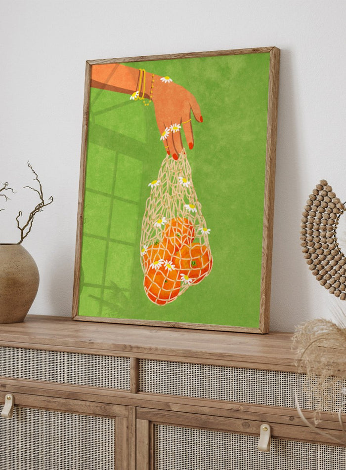 Illustration of a hand holding a bag of oranges with a green background. Fresh Oranges by Raissa Oltmanns fine art print featuring modern fruit illustration, stylish feminine hand art, contemporary kitchen wall decor poster.