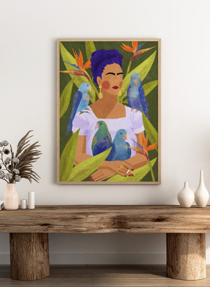 Artistic depiction of a woman with blue hair surrounded by parrots and tropical plants. Frida and Birds by Raissa Oltmanns is a modern Frida Kahlo inspired art print with tropical birds and bold botanical wall poster design.