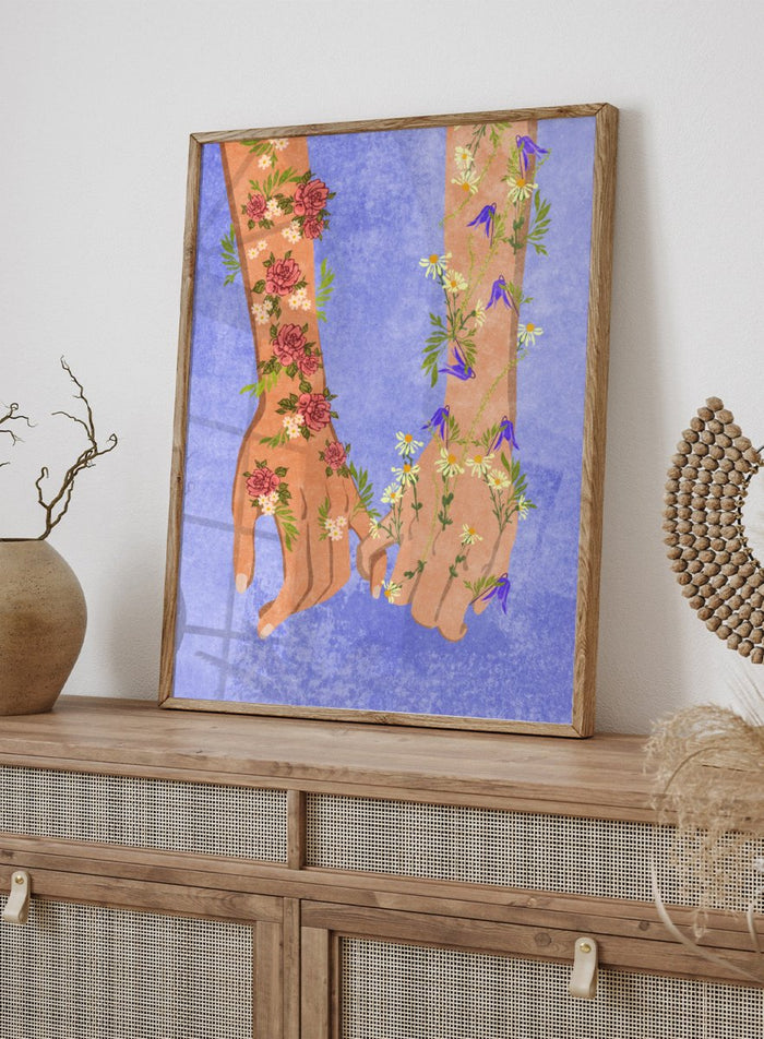 Illustration of two hands holding each other with floral designs on a blue background. Holding Hands by Raissa Oltmanns is a modern romantic fine art print featuring floral arms illustration and contemporary love wall decor poster.