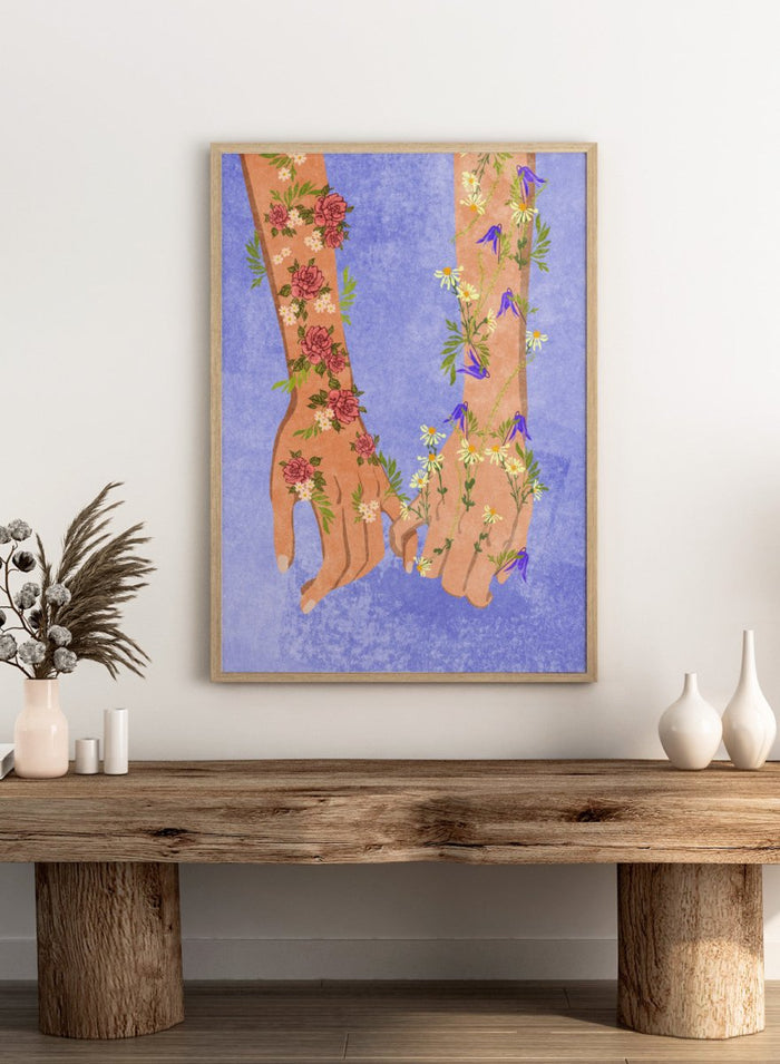 Illustration of two hands holding each other with floral designs on a blue background. Holding Hands by Raissa Oltmanns is a modern romantic fine art print featuring floral arms illustration and contemporary love wall decor poster.