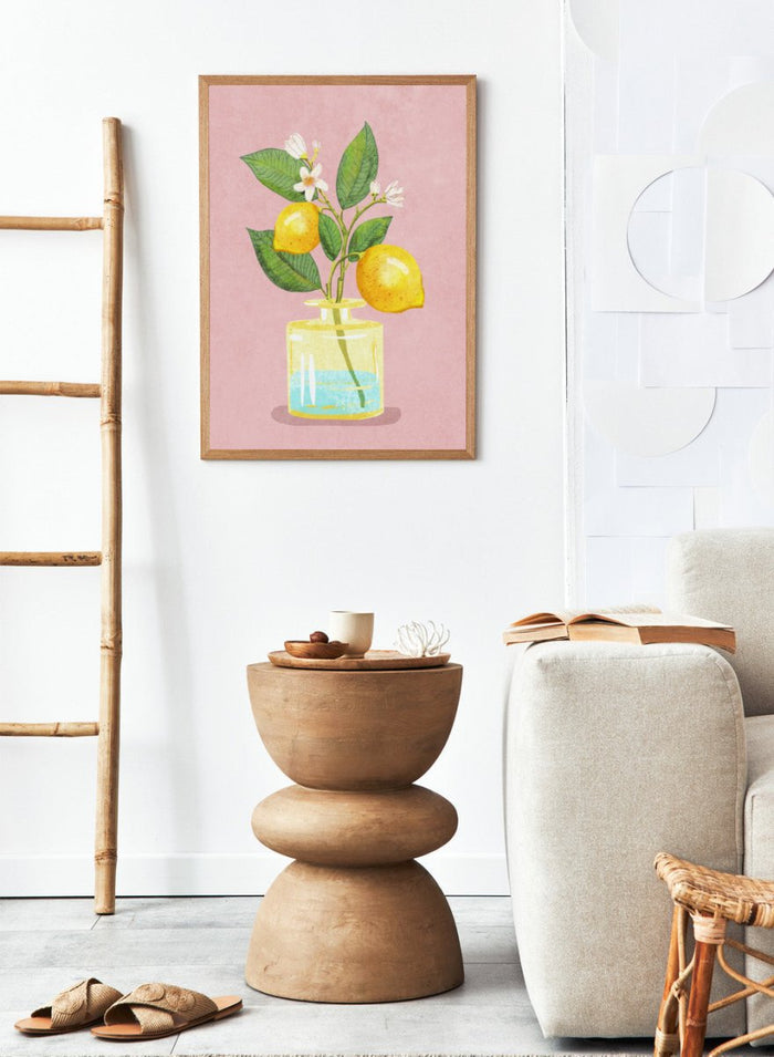 Illustration of lemons and a flower in a glass bottle on a pink background. Lemon Bunch In Vase by Raissa Oltmanns is a modern lemon still life art print featuring citrus fruit and floral kitchen wall poster design.