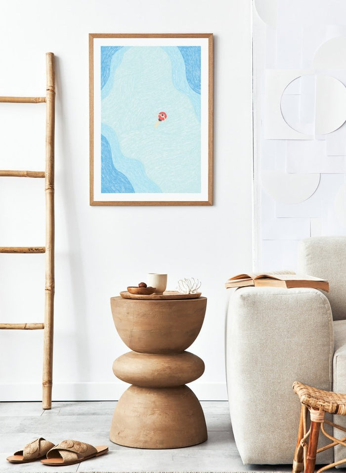 Calm Summer Swim by Rio Soléy is a minimalist coastal art print featuring a lone swimmer, soft blue water, playful illustration, and relaxed summer vibes.