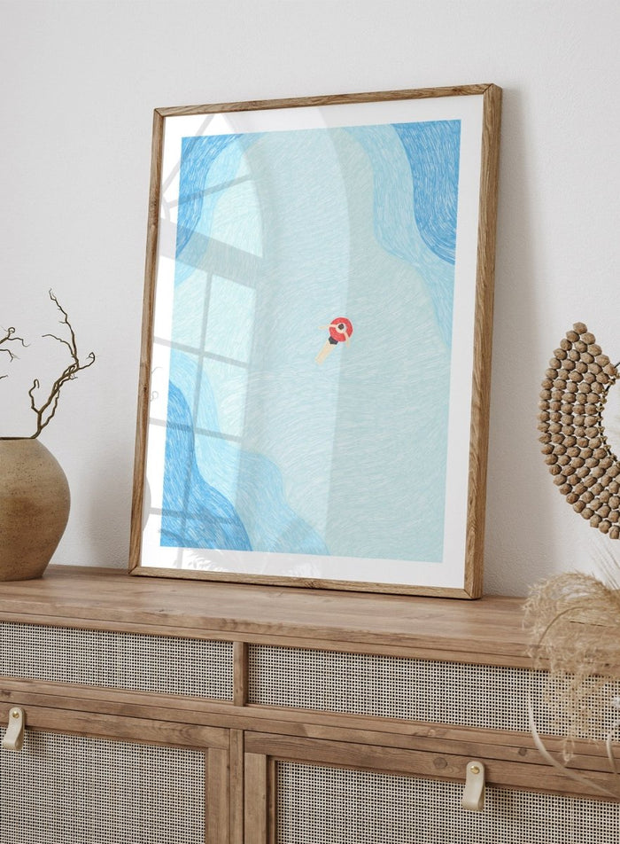Calm Summer Swim by Rio Soléy is a minimalist coastal art print featuring a lone swimmer, soft blue water, playful illustration, and relaxed summer vibes.
