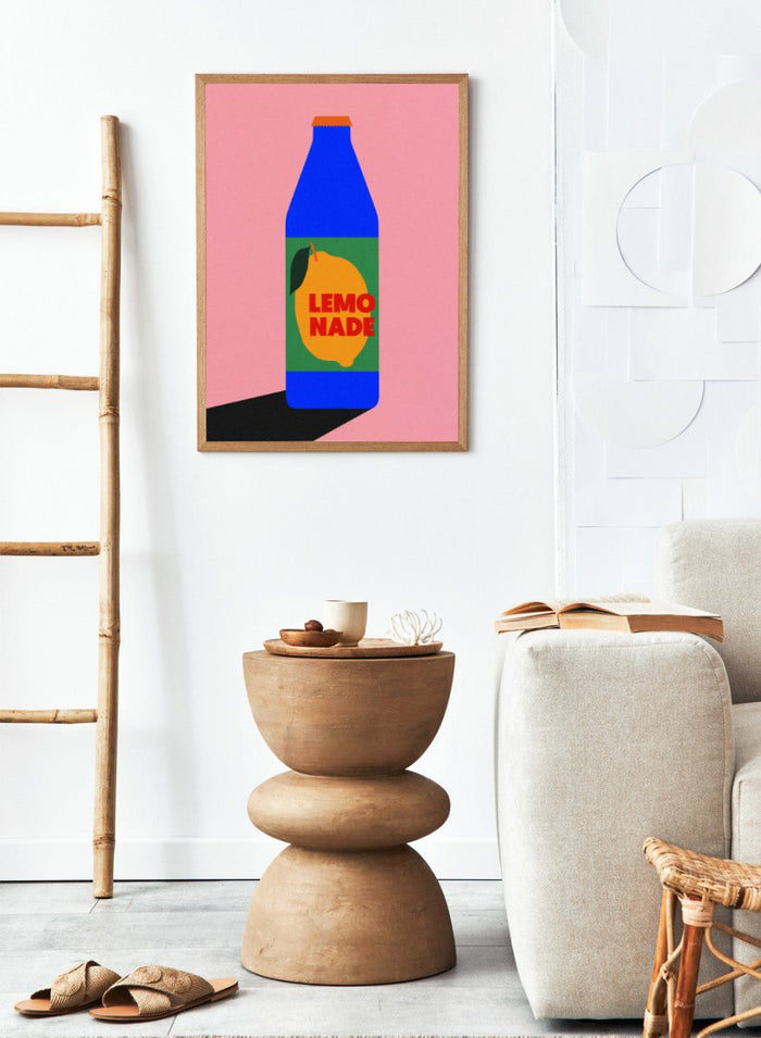 Blue bottle labeled 'Lemonade' with a lemon graphic on a pink background. Lemonade by Rosi Feist is a contemporary food and drink art print, perfect as modern kitchen poster wall decor with bold graphic design.