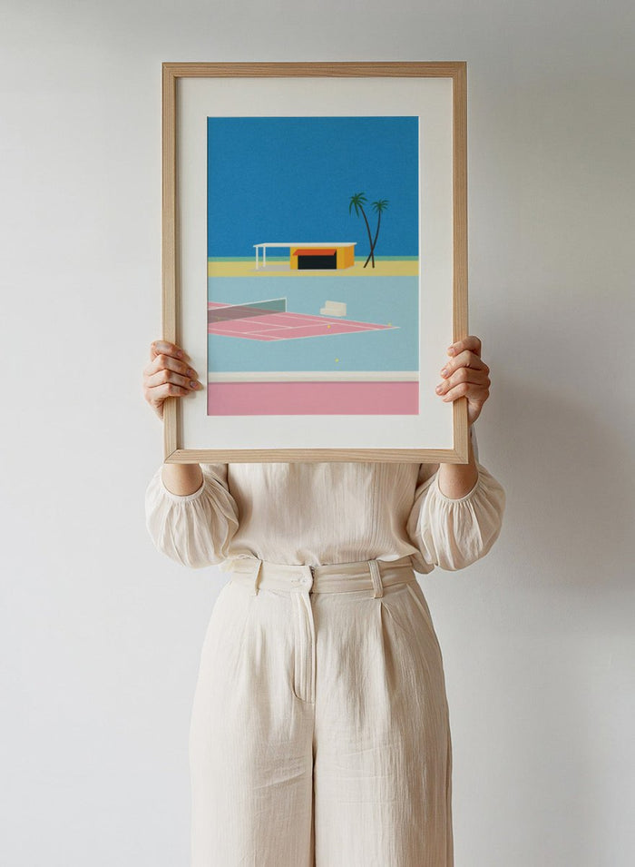 Simplified illustration of a tennis court with a small building and palm trees against a blue sky. Tennis By the Beach by Rosi Feist is a minimalist modern art print of a tennis court beside beach and palm trees. Officially licensed fine art poster with framing.
